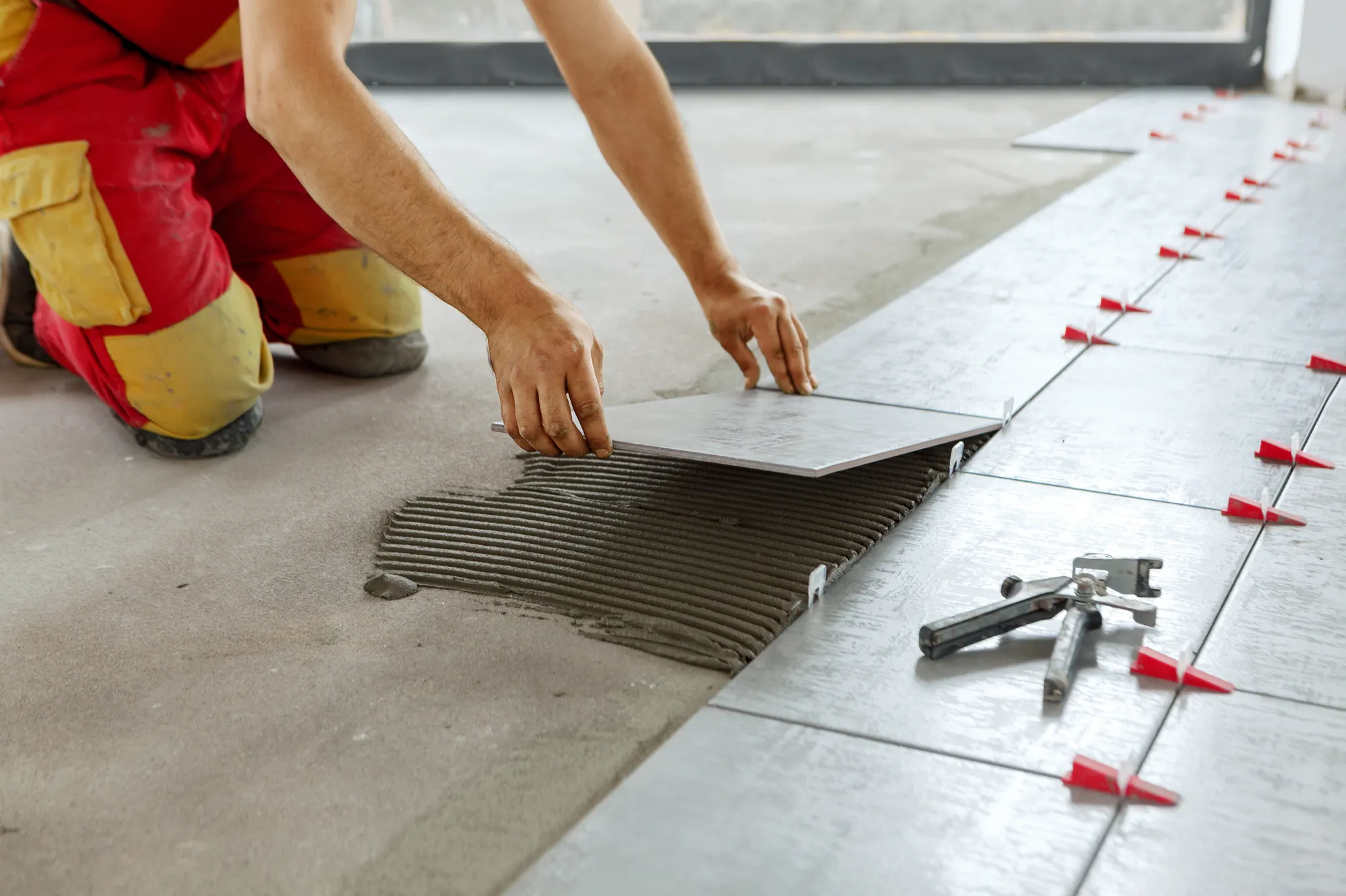 Ceramic tile being laid on a Bent General Contracting job